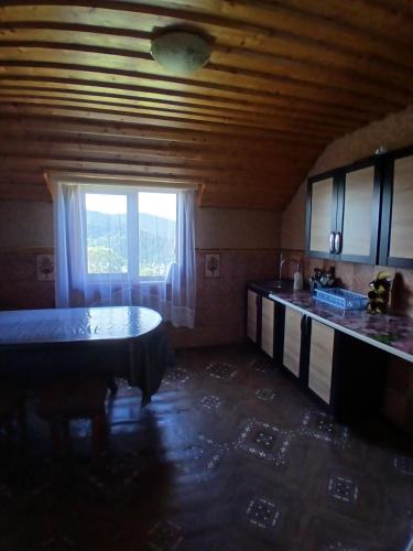 a kitchen with a table and a window at Гірська вершина in Slavske