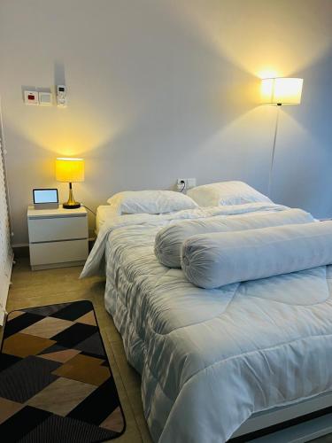 a bedroom with two beds and a lamp on a table at Condo Center Point Phnom Penh City - Time Square 2 Apartment in Phnom Penh
