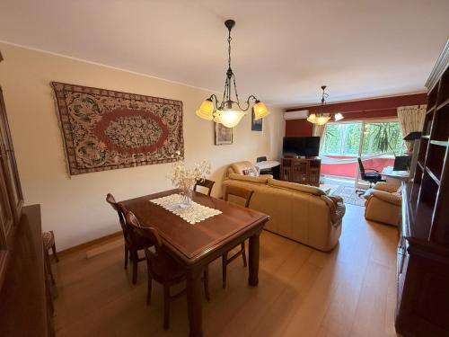 a living room with a table and a couch at Cozy and Quiet Apartment near the Center in Braga