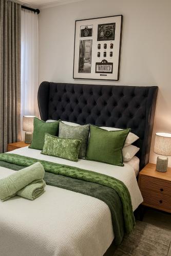 a bedroom with two beds with green pillows at Urban Contempo Lush in Fourways