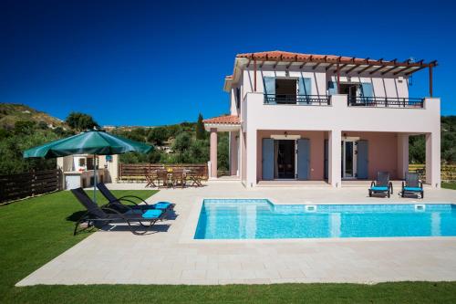 a villa with a swimming pool and a house at Armonia Villas in Lixouri