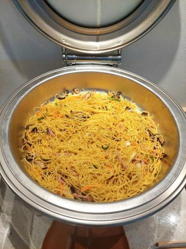 a pot full of shredded cheese in a pan at PAAK Hotel Suvarnabhumi in Lat Krabang
