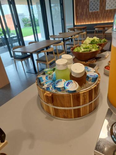 a table topped with a bowl of food on a table at PAAK Hotel Suvarnabhumi in Lat Krabang