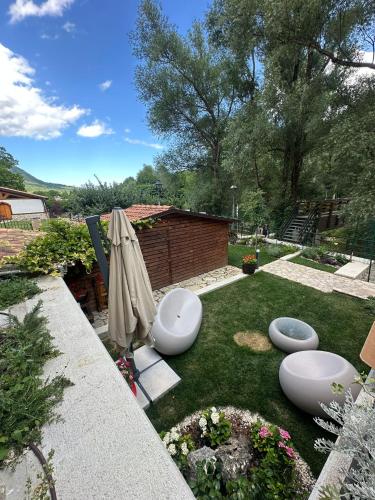 a garden with three toilets sitting on the grass at Albergo Pineta dal 1891 in Villetta Barrea