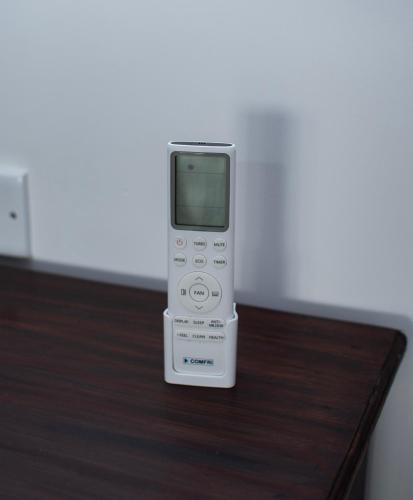 a cell phone sitting on top of a wooden table at Danish Crown Hotel in Ambalangoda
