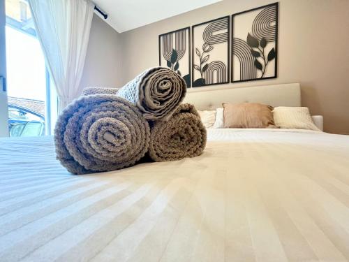 a bedroom with a bed with blankets on it at Lake and Trail, Free Parking, Near Nature and City in Neuchâtel