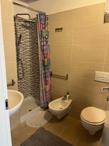 a bathroom with a toilet and a sink and a shower at La Stanzetta Viola in Fezzano