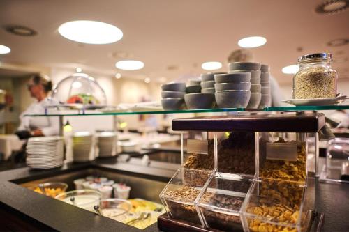 a kitchen with a counter with some food on it at Hotel Gasthof Krönele in Lustenau