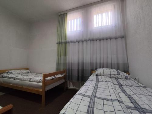 Postel nebo postele na pokoji v ubytování White Apartment