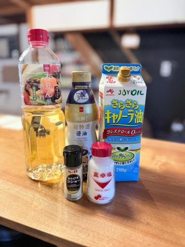 a table with a bottle of oil and other ingredients at 宿たぬきのねどこ GUESTHOUSE TANUKI in Tokoname