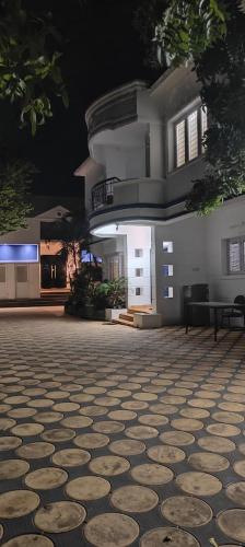 a building with a stone floor in front of it at LALITHA enclove in Tirupporūr