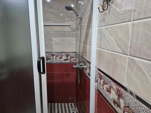 a bathroom with a shower with a glass door at Appartment Mirador Al Hoceima in Al Hoceïma