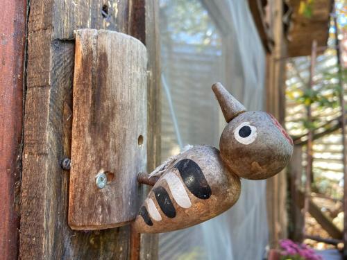 a wooden door with a stuffed animal on it at Η Χαρούμενη Αρκούδα in Pávliani