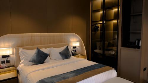 a bedroom with a large bed with two pillows at Grand Day Hotel Boutique in Al Hofuf