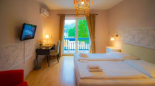 Ένα ή περισσότερα κρεβάτια σε δωμάτιο στο Loving Hut Pension & Restaurant