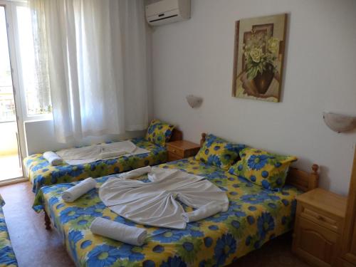a small room with two beds and a window at Guest house Stoyanovi in Chernomorets