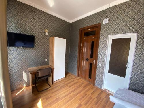 a room with a hallway with a chair and a door at Ziyo hotel in Yalanghoch