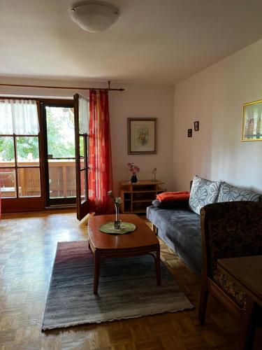 a living room with a couch and a coffee table at FeWo Feil süd in Freilassing