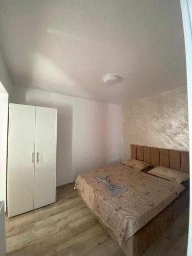a bedroom with a bed and a white cabinet at LCB Apartments G Enescu 19 in Suceava