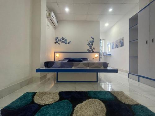 a bedroom with a bed and a rug on the floor at New View Homestay in Veer Savarkar International Airport