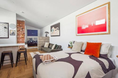 a bedroom with a bed and a living room at Fremantle Swan River Studio in East Fremantle