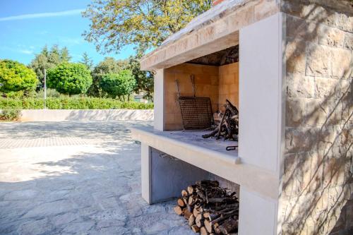 a outdoor oven with a pile of fire wood at Summer Breeze in Gornji Humac