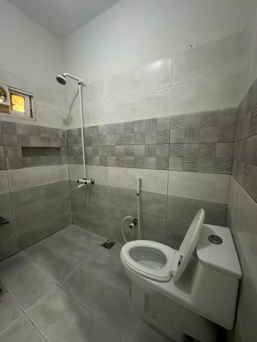a bathroom with a toilet and a shower at Seaview Residency in Karachi