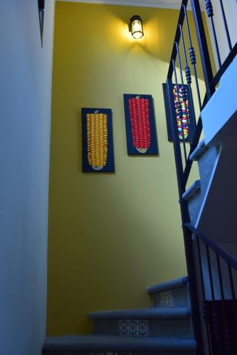 a stairway with two flags on a green wall at Kakaw's house, pool with a view of the 3 volcanoes in San Juan Alotenango