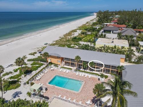 an aerial view of a resort with a swimming pool and the beach at Vitamin Seaside Open August 17th and 18th! in Longboat Key