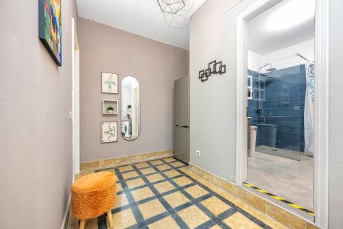 a bathroom with a walk in shower and a mirror at Lunin Apartments in Las Palmas de Gran Canaria