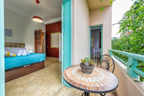 a room with a balcony with a bed and a table at Lunin Apartments in Las Palmas de Gran Canaria