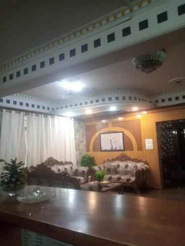 a living room with couches and a table at Hotel Tela Family stay Near IGI Airport Delhi 