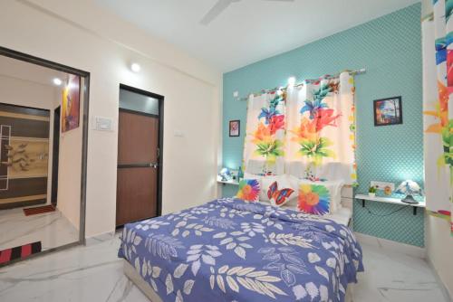 a bedroom with a bed and a blue wall at ll EMPYREAN STAY ll LEONCINO VILLA ll 4BHK ll AC ll LONGEST PRIVATE POOL IN LONAVALA ll in Lonavala