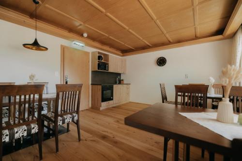 a kitchen and dining room with a table and chairs at KERSCHDORFER - wohlfühlhotel garni - adults only in Kaltenbach