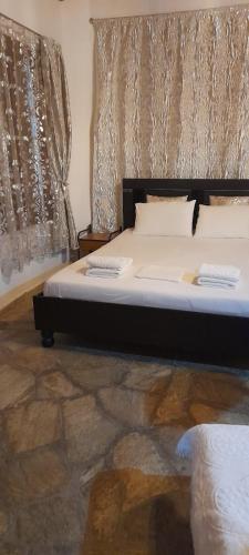 a bedroom with a bed with two monitors on it at Γοργονα in Voutás