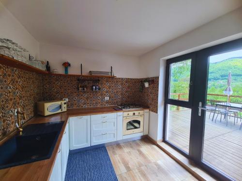 a kitchen with a stove top oven next to a window at Bran Mountain Living in Bran