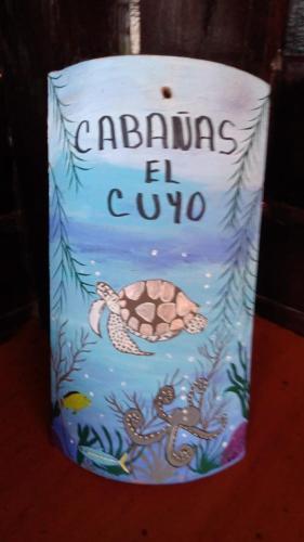 a cake with a turtle and the words graduating el club at Cabañas El Cuyo in El Cuyo