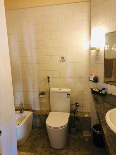a bathroom with a toilet and a sink and a tub at Crystal Villa Weligama in Weligama