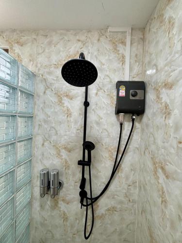 a shower in a bathroom with a shower head at เขาลมเย็น in Khao Kho