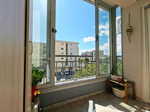 a balcony with windows and a view of a city at The Lilac Lounge in Podgorica