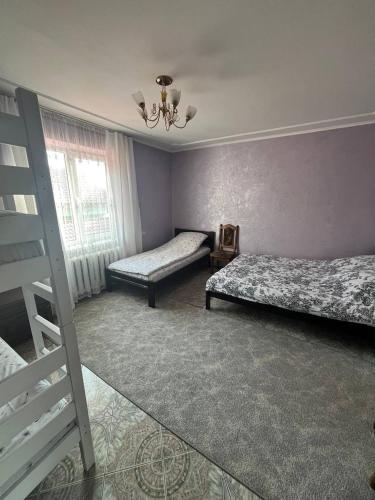 a bedroom with two beds and a ladder at Smerichka in Zagorody