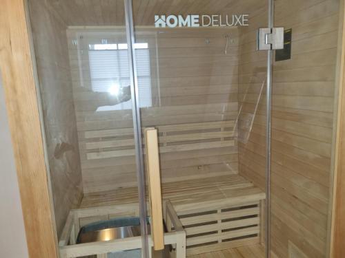 a sauna with a shower with a sink in it at Ferienhaus Pfeffermuschel in Neßmersiel