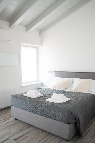 Katil atau katil-katil dalam bilik di Borgo Gemona Luxury Suites