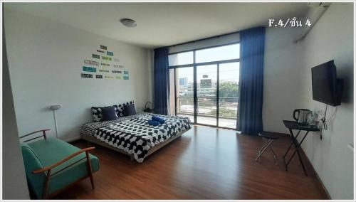a bedroom with a bed and a large window at HOMEY-Sleepy Don Mueang Airport Hostel in Bangkok