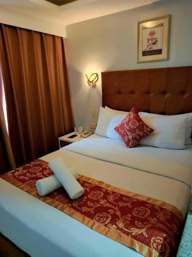 Ένα ή περισσότερα κρεβάτια σε δωμάτιο στο JMM Grand Suites