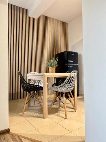 a dining room with a table and two chairs at Apartament Olszowka 12 Bielsko - Biała in Bielsko-Biała