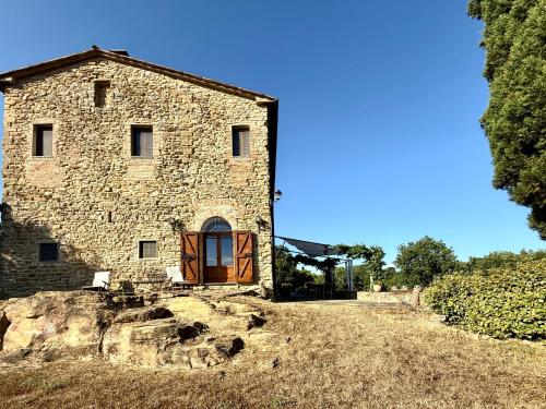 an old stone building on top of a hill at Torre della Soara - Medieval Tower in the Umbrian Countryside in Città di Castello
