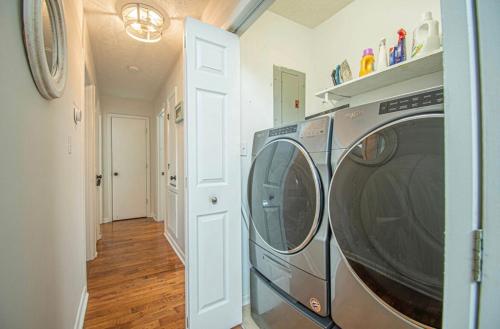 a kitchen with a washing machine in a hallway at Turtle Time! in Oak Island