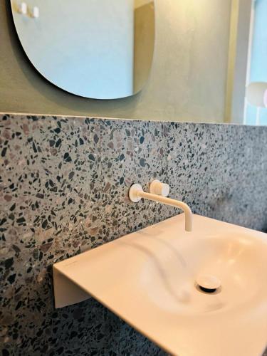 a bathroom with a white sink and a mirror at Sky & Sea - Ramsgate in Ramsgate
