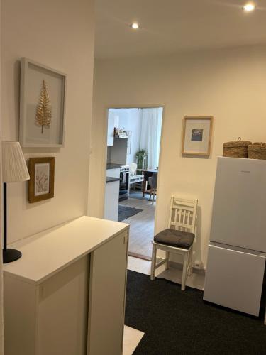 a kitchen with a white refrigerator and a chair at penzion LILIE - SEDMIČKA in Litomyšl
